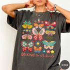Comfort Colors tee in Pepper featuring butterfly and floral graphic design with Be Kind to all kinds text