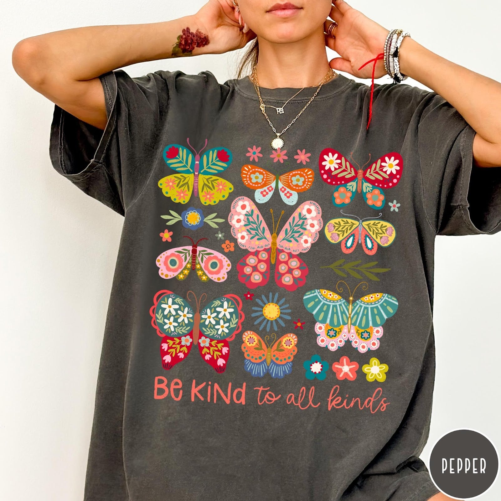 Comfort Colors tee in Pepper featuring butterfly and floral graphic design with Be Kind to all kinds text