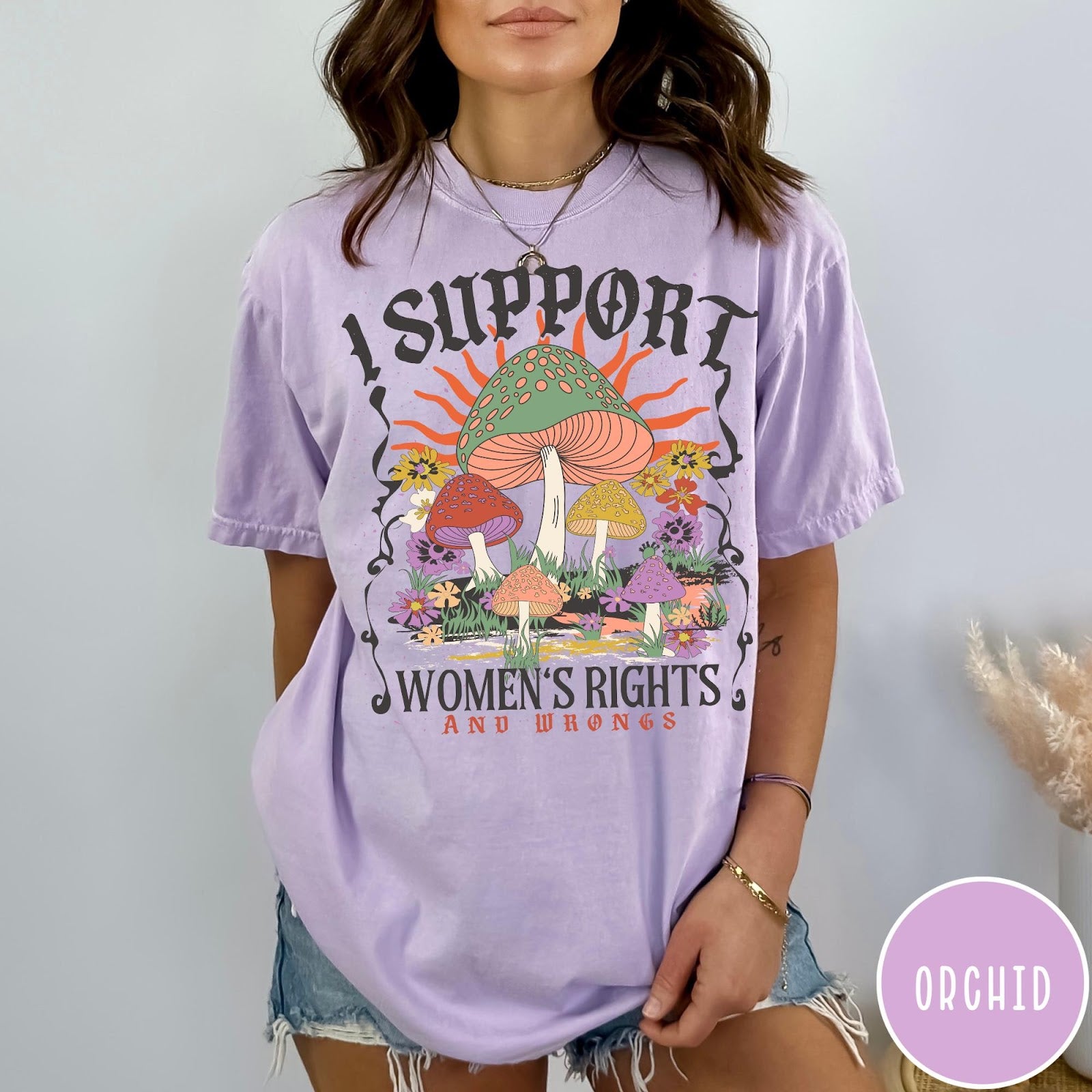 Comfort Colors tee in Orchid featuring retro style graphic with mushrooms, flowers, and sun with inspirational text
