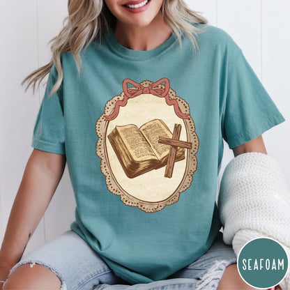Comfort Colors tee in Seafoam featuring vintage style graphic of an open Bible and wooden cross