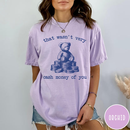 Comfort Colors tee in Orchid featuring graphic style teddy bear sitting on a stack of coins