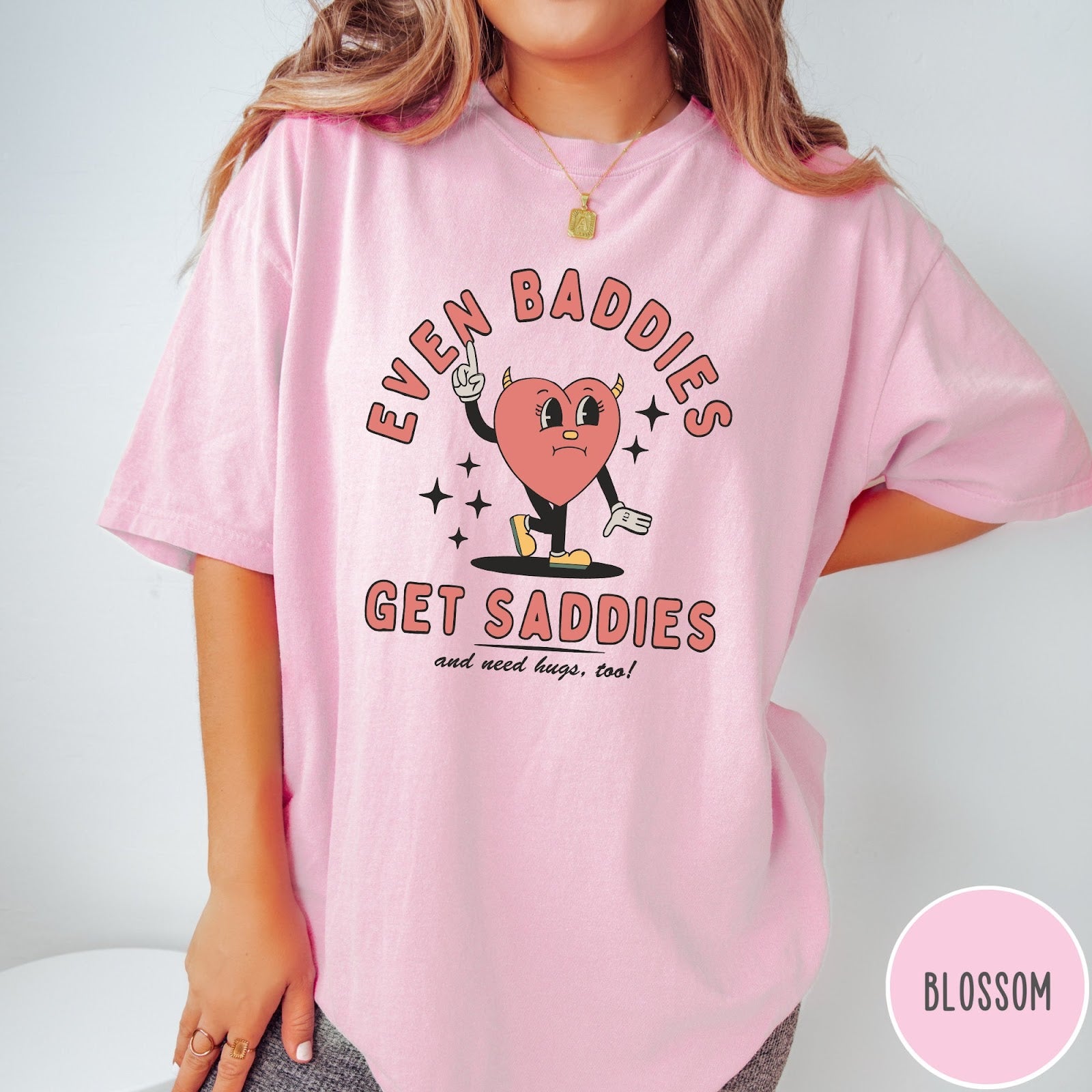 Comfort Colors tee in Blossom featuring retro style graphic of a sad heart character with devil horns