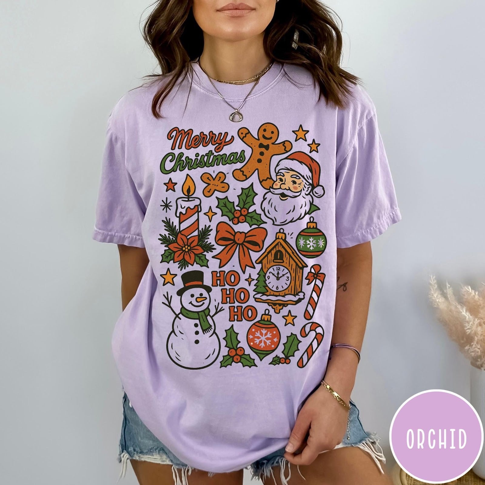 Comfort Colors tee in Orchid featuring retro holiday design with Christmas icons like Santa and a snowman