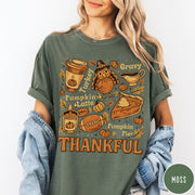 Comfort Colors tee in Moss featuring retro Thanksgiving dinner items including turkey, pumpkin latte, and pumpkin pie graphic