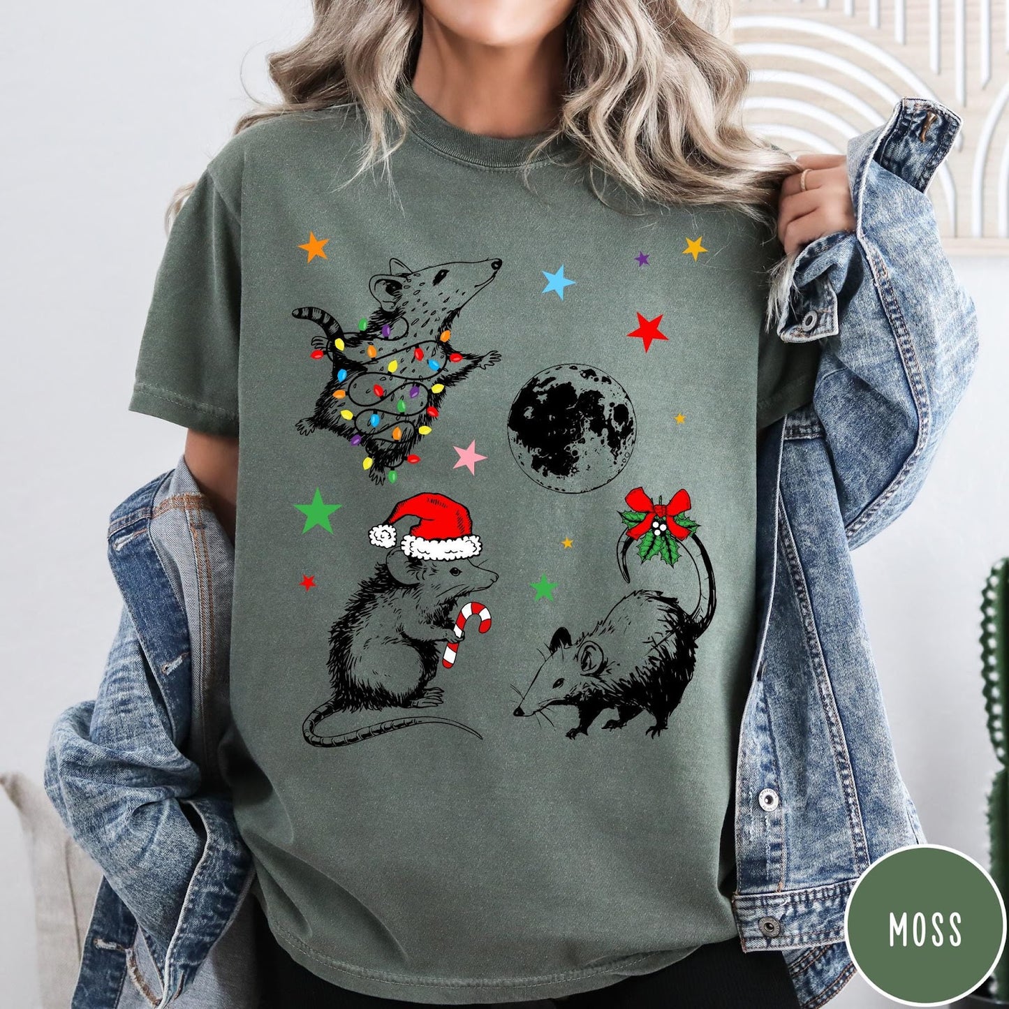 Comfort Colors tee in Moss featuring holiday possum graphic with Christmas lights, candy cane, and moon.
