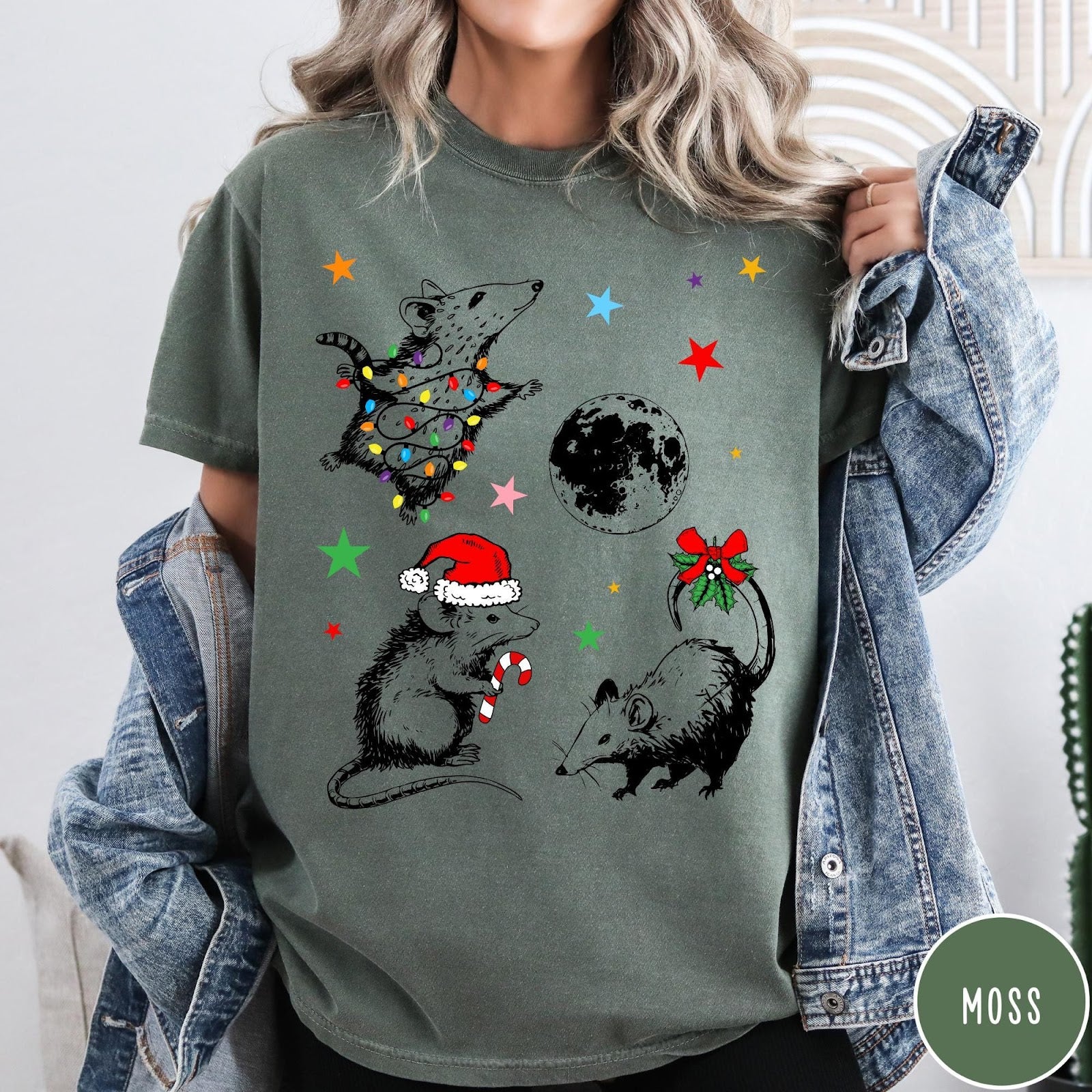 Comfort Colors tee in Moss featuring holiday possum graphic with Christmas lights, candy cane, and moon.