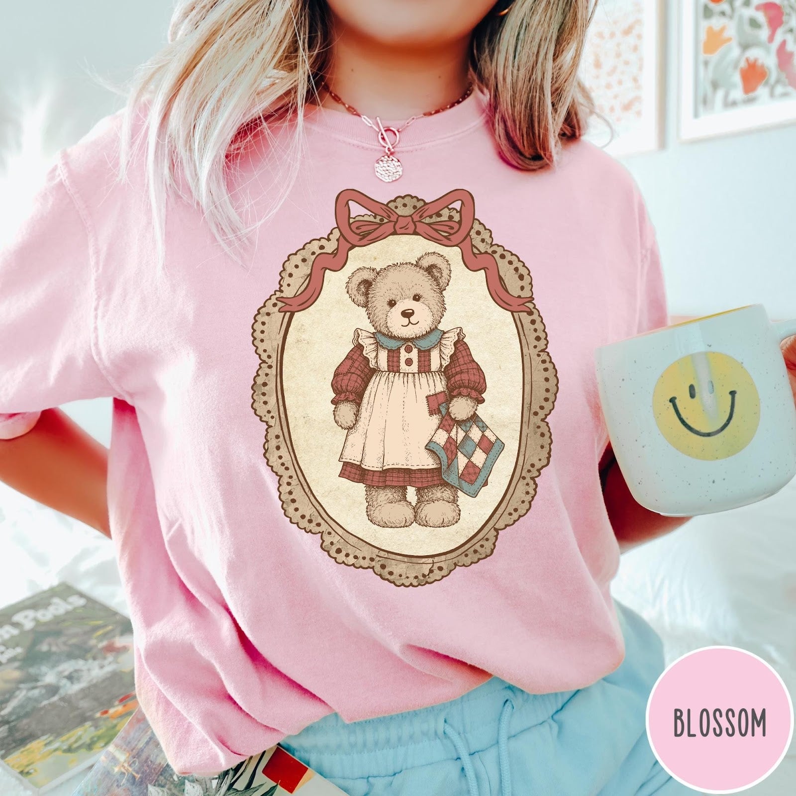 Comfort Colors tee in Blossom featuring vintage style teddy bear graphic inside a decorative lace oval frame