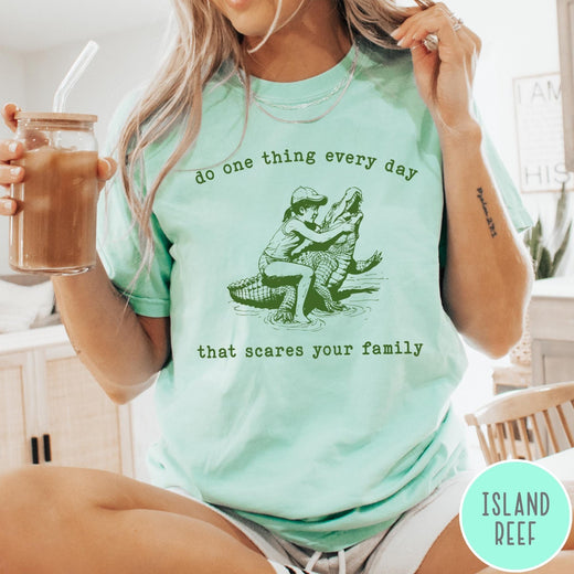 Comfort Colors tee in Island Reef featuring vintage style graphic of a girl wrestling an alligator