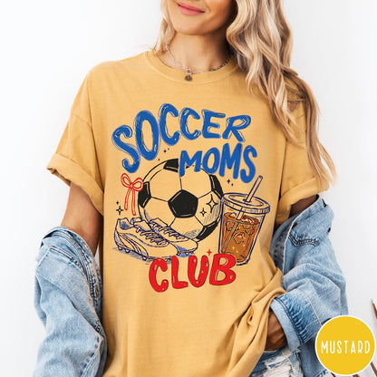 Comfort Colors tee in Mustard featuring soccer mom lifestyle graphic with soccer ball, cleats, and iced coffee