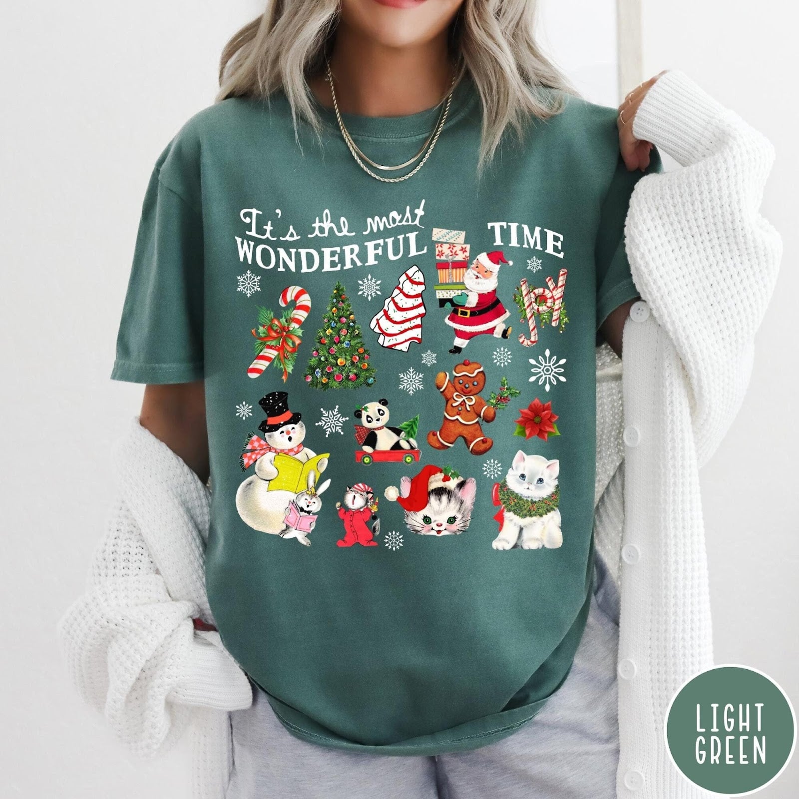 Comfort Colors tee in Light Green featuring Christmas collage graphic with Santa, snowman, animals, and holiday icons