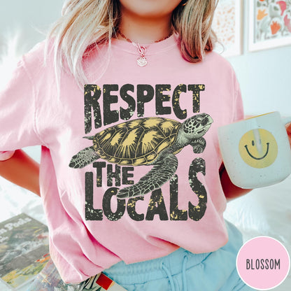 Comfort Colors tee in Blossom featuring vintage style sea turtle graphic with Respect the Locals text