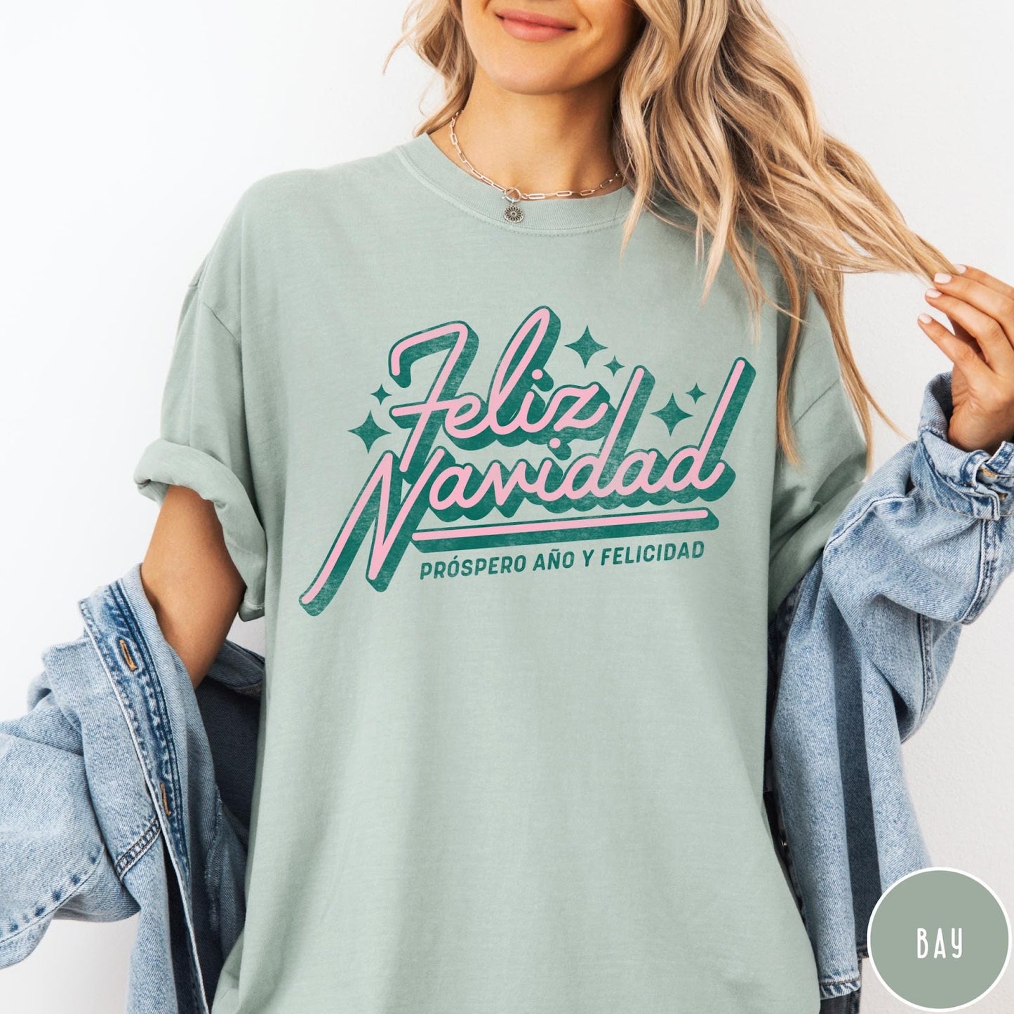 Comfort Colors tee in Bay featuring retro Christmas style Feliz Navidad greeting with stars and holiday text
