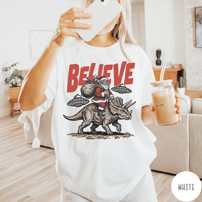 Comfort Colors tee in White featuring vintage style graphic of Santa riding a dinosaur with flying saucers