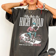 Comfort Colors tee in Pepper featuring vintage style graphic of a woman riding a tricycle with wine