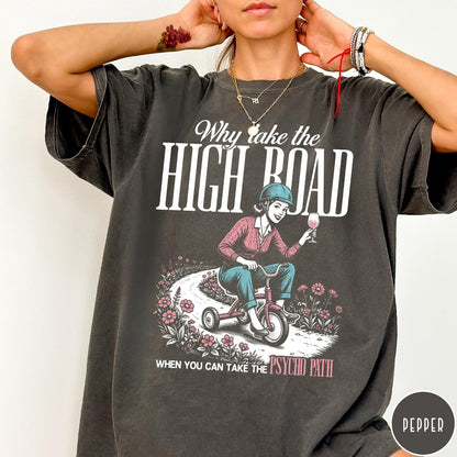Comfort Colors tee in Pepper featuring vintage style graphic of a woman riding a tricycle with wine