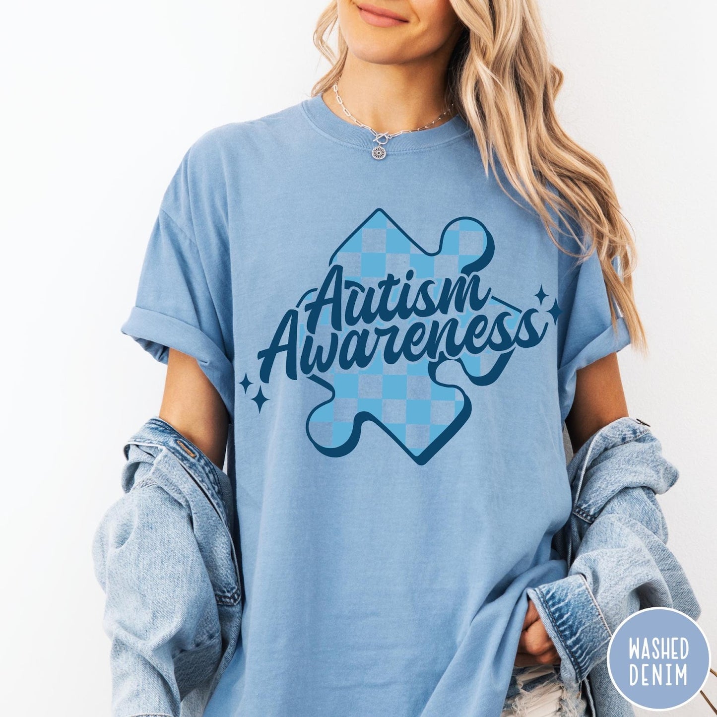 Comfort Colors tee in Washed Denim featuring screen print style Autism Awareness puzzle piece with blue checkerboard pattern
