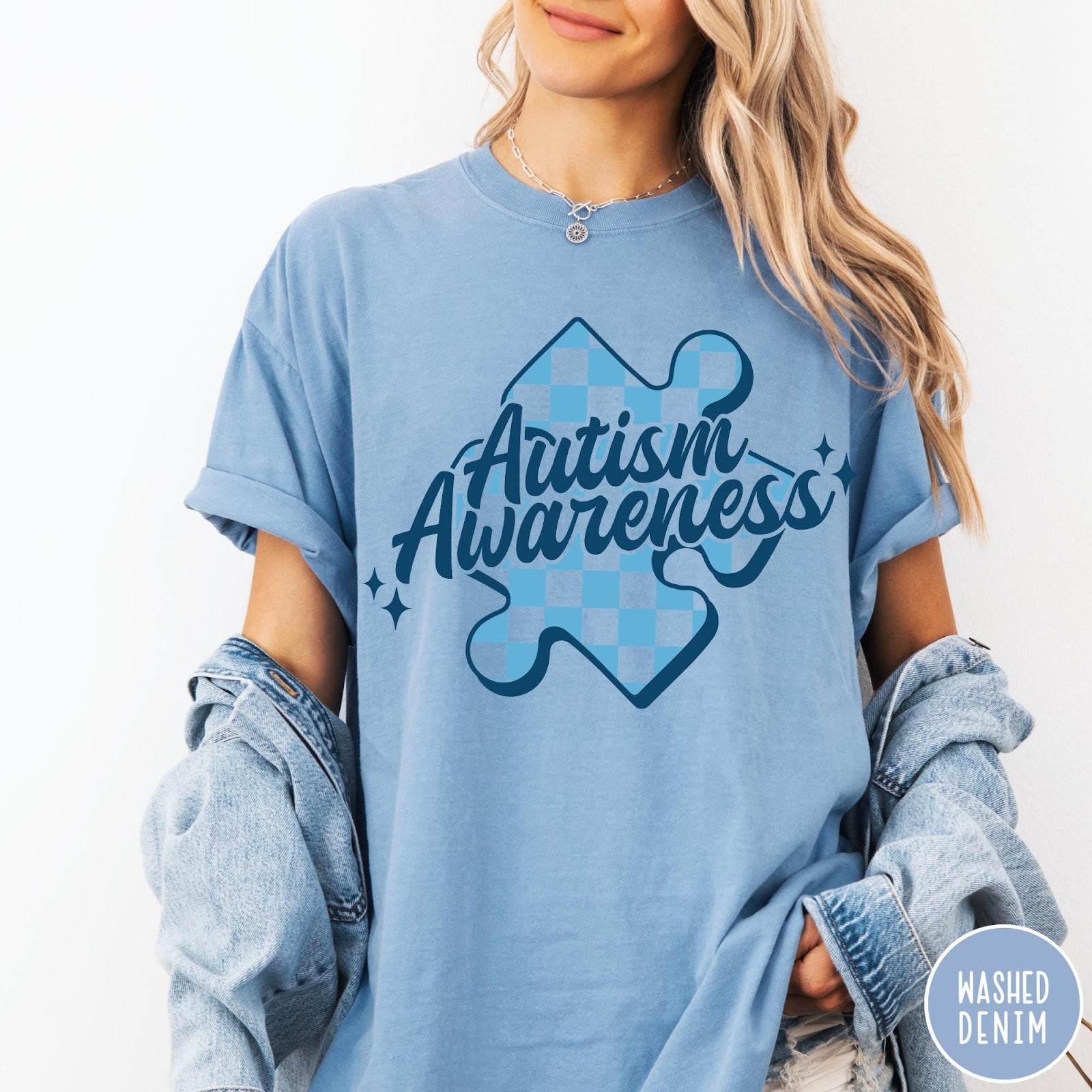 Comfort Colors tee in Washed Denim featuring screen print style Autism Awareness puzzle piece with blue checkerboard pattern