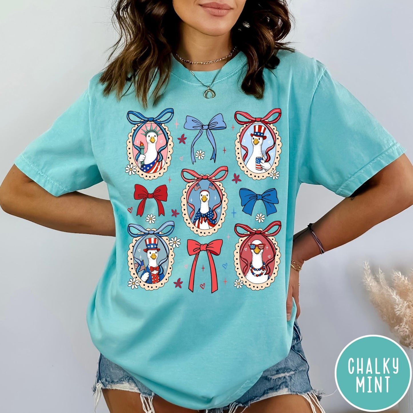 Comfort Colors tee in Chalky Mint featuring coquette style patriotic goose graphic with bows and floral accents