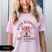 Comfort Colors tee in Pink featuring retro style sad heart character with horns and text graphic