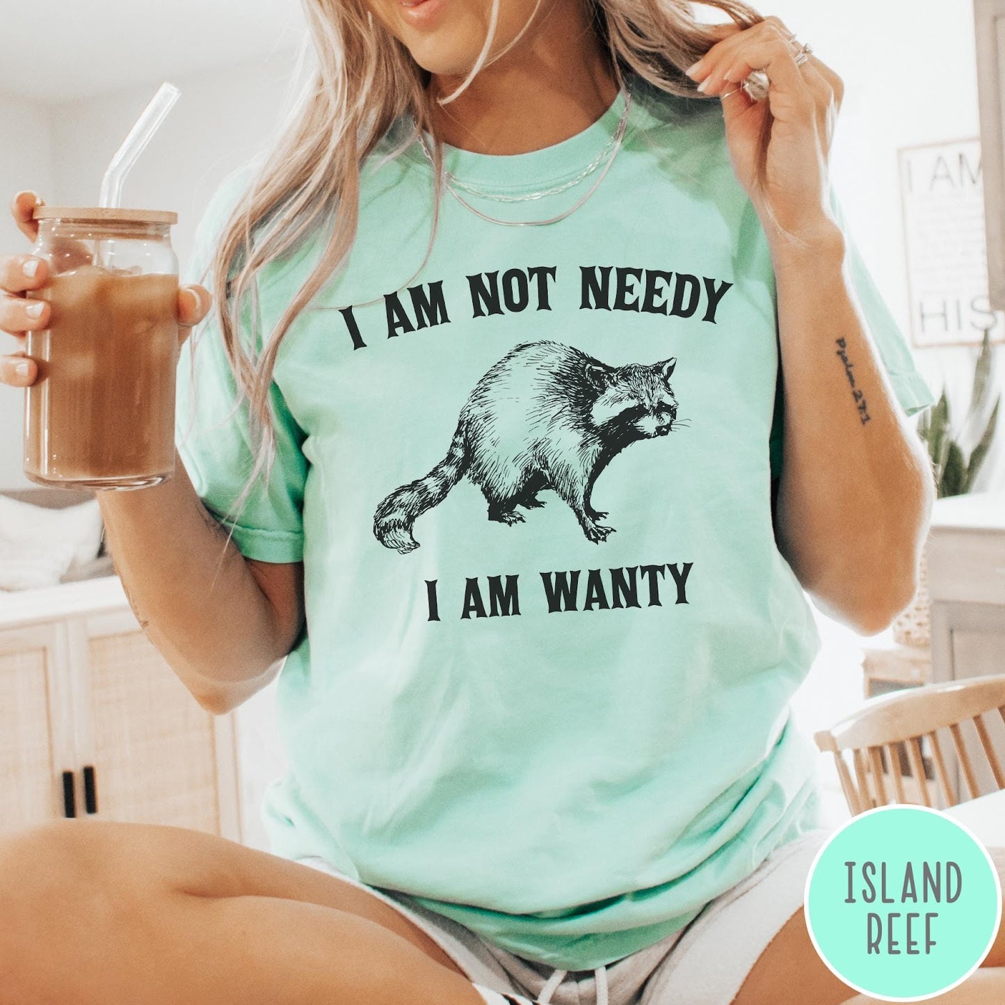 Comfort Colors tee in Island Reef featuring vintage style graphic of a raccoon with text I Am Not Needy