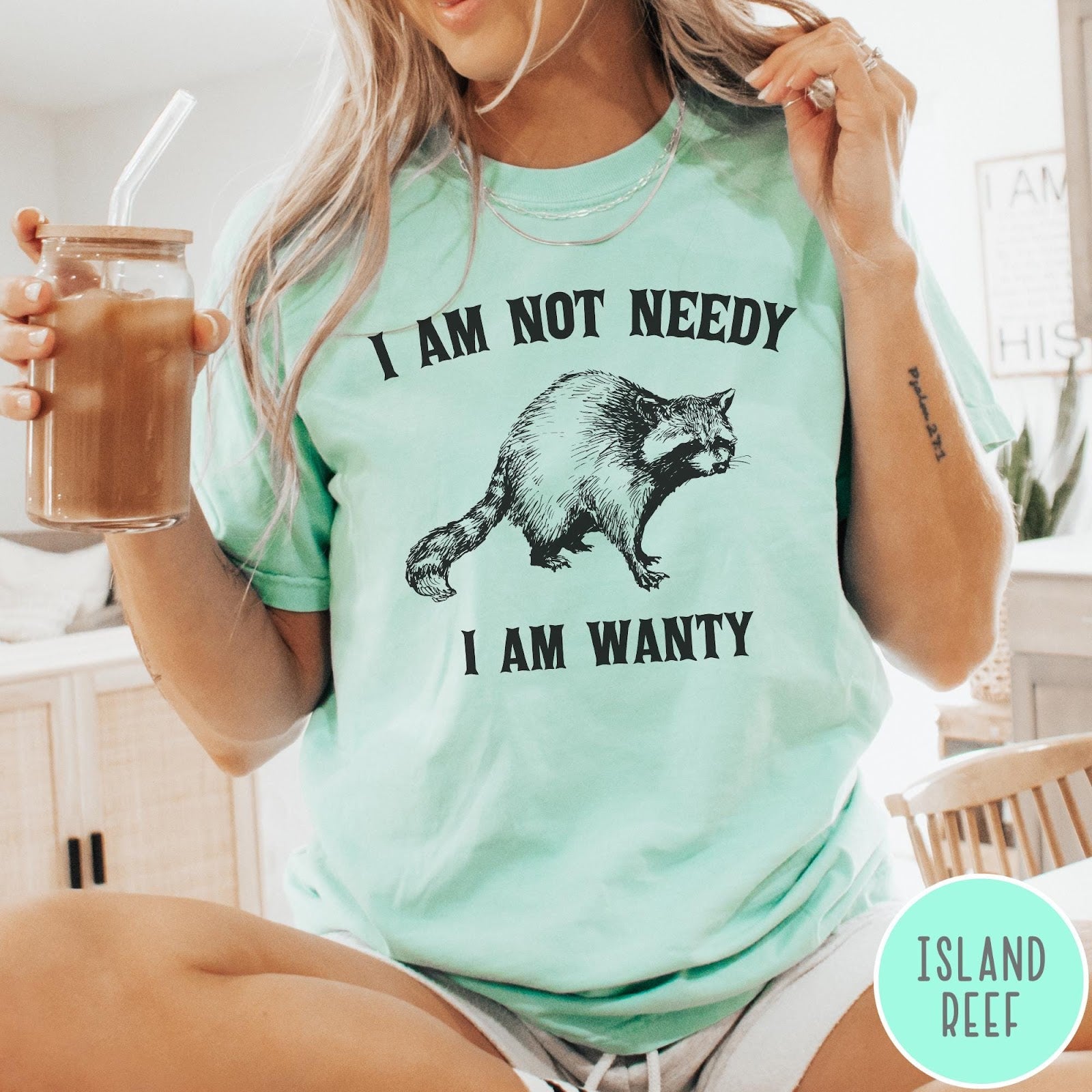 Comfort Colors tee in Island Reef featuring vintage style graphic of a raccoon with text I Am Not Needy