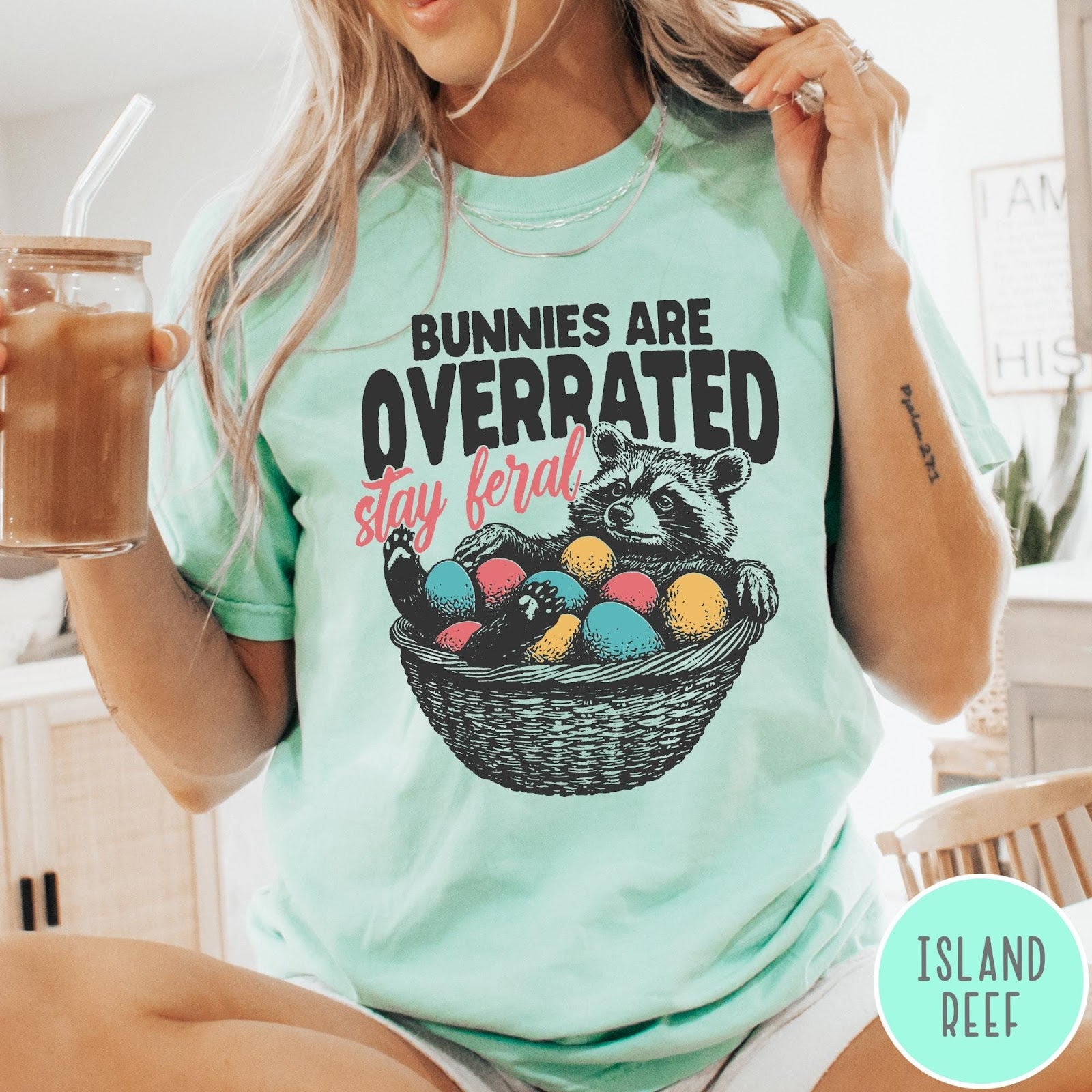 Comfort Colors tee in Island Reef featuring graphic illustration of a raccoon sitting in an Easter basket