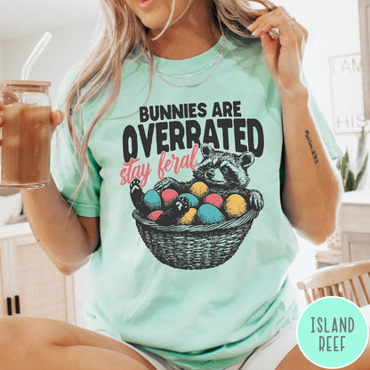 Comfort Colors tee in Island Reef featuring graphic illustration of a raccoon sitting in an Easter basket