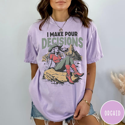 Comfort Colors tee in Orchid featuring western style graphic of a cowgirl sitting on a rock drinking