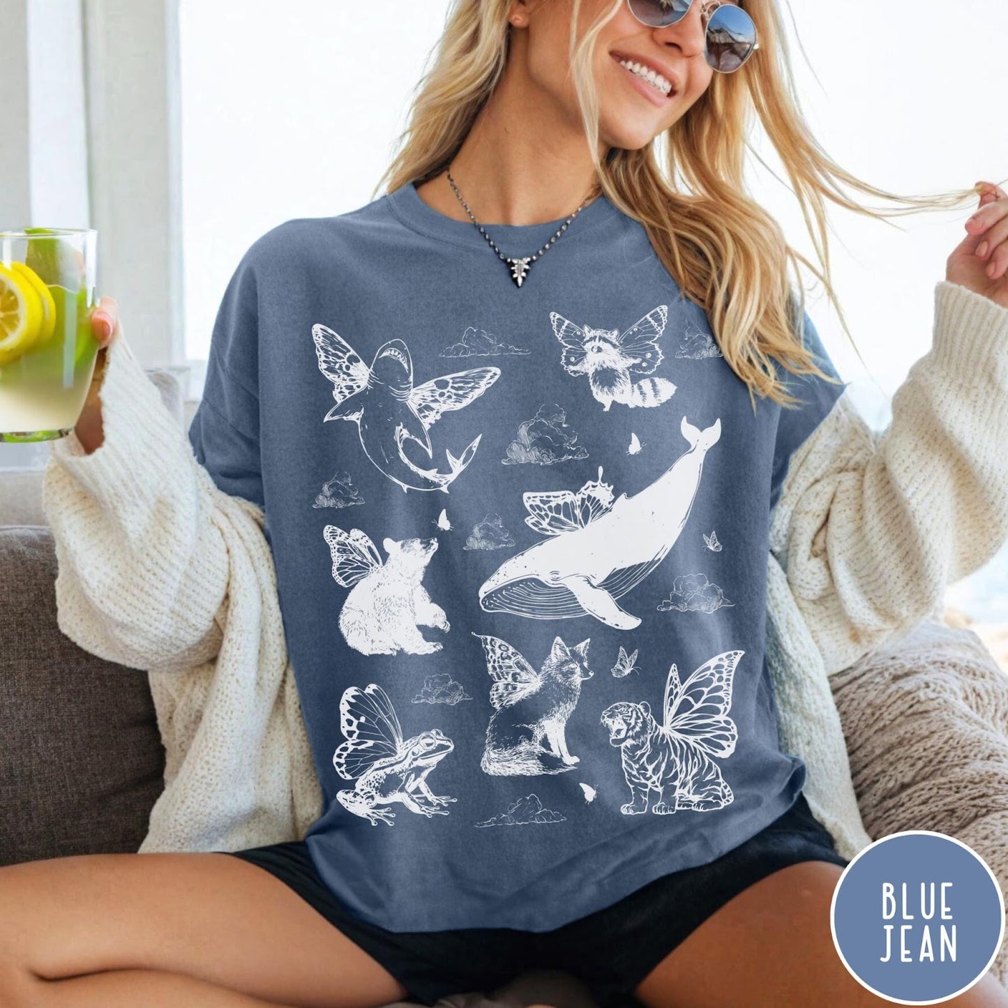 Comfort Colors tee in Blue Jean featuring vintage style graphic of various animals with butterfly wings and clouds