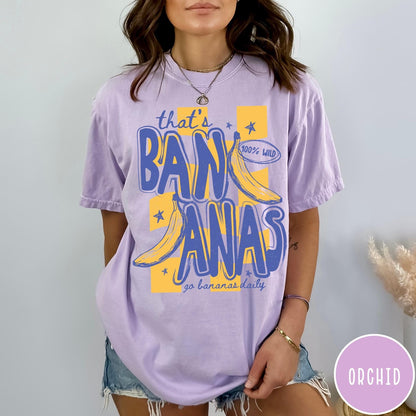 Comfort Colors tee in Orchid featuring retro style banana graphic with text that is bananas go bananas daily