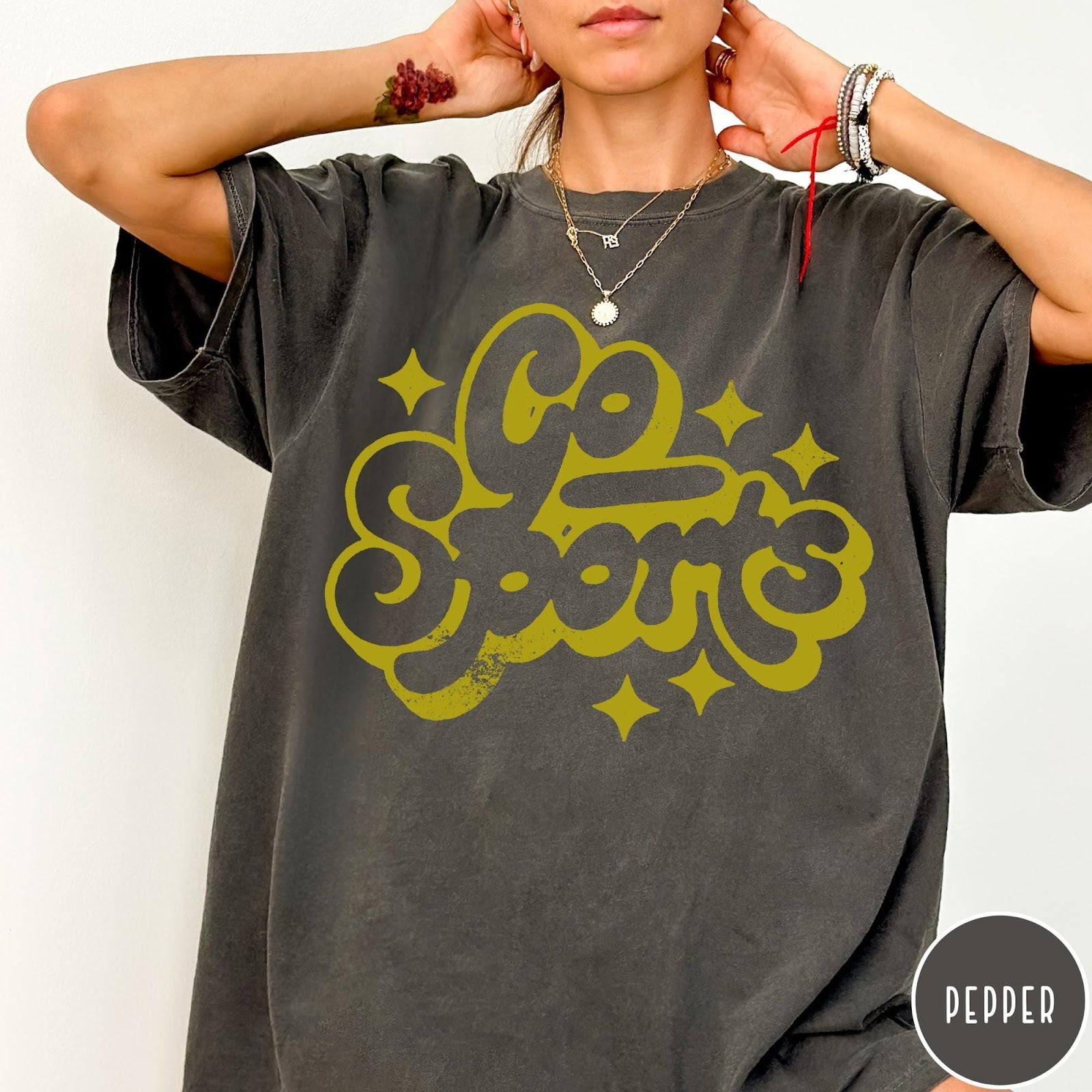 Comfort Colors tee in Pepper featuring retro sports style graphic with Go Sports text and star accents