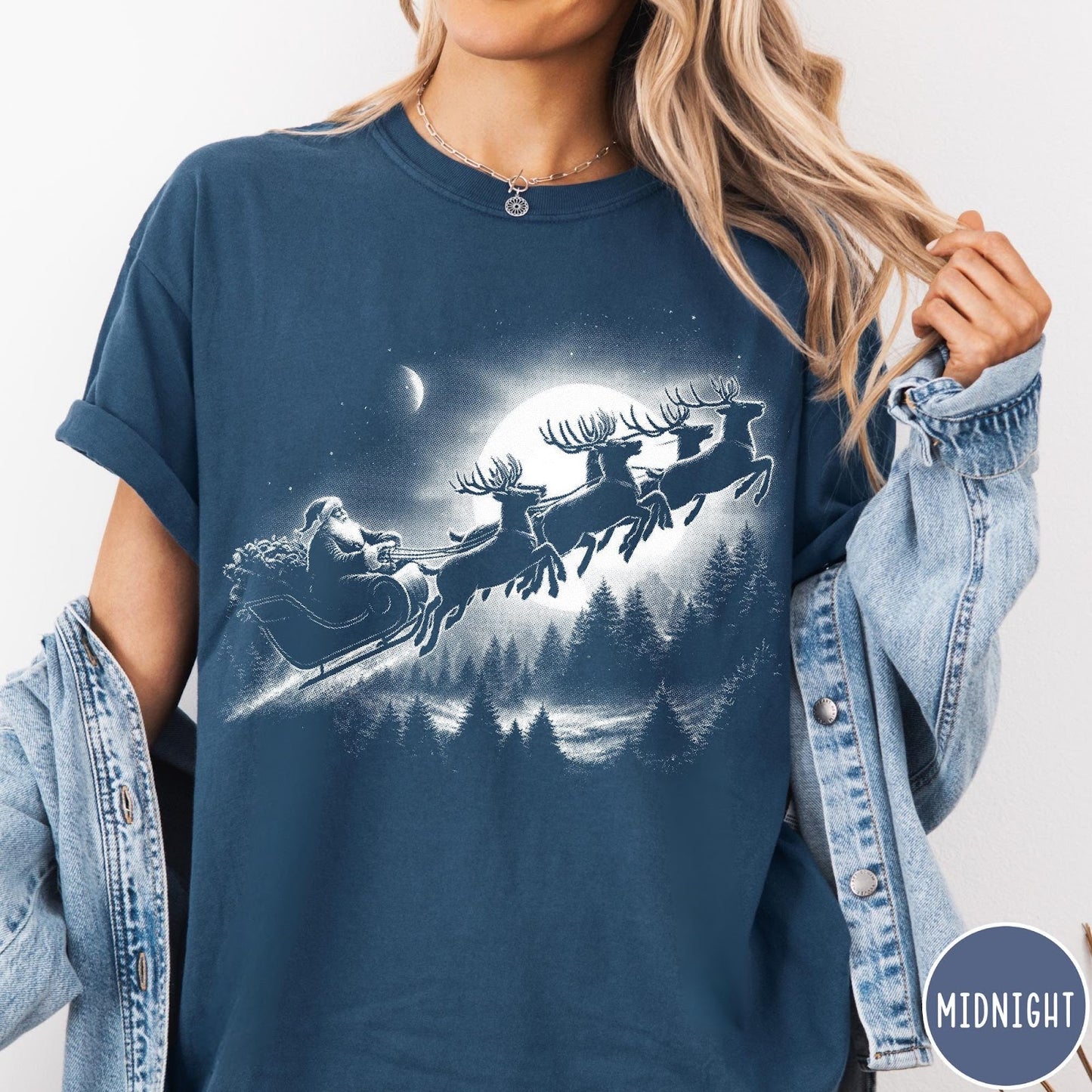 Comfort Colors tee in Midnight featuring vintage style graphic of Santa Claus flying his sleigh with reindeer
