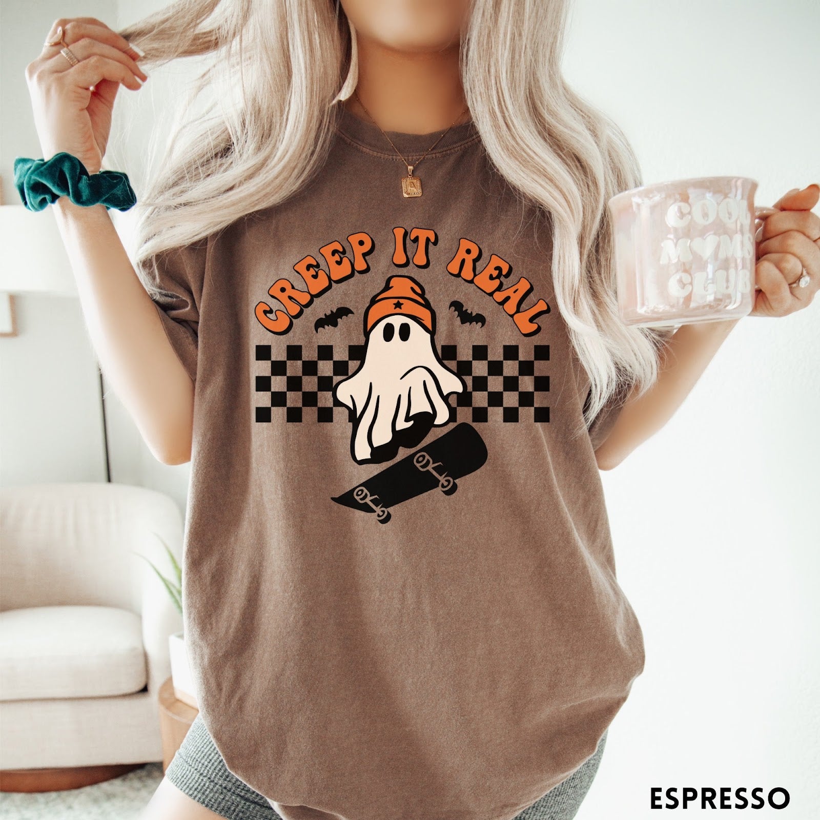 Comfort Colors tee in Espresso featuring retro style ghost graphic with skateboard and checkered background pattern