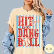 Comfort Colors tee in Butter featuring baseball design with red text and a blue striped background graphic