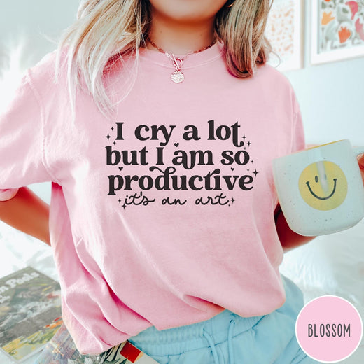 Comfort Colors tee in Blossom featuring mental health humor graphic text I Cry but Productive