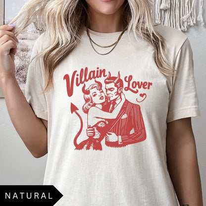 Comfort Colors tee in Natural featuring vintage style graphic of a devilish couple embracing with text Villain Lover