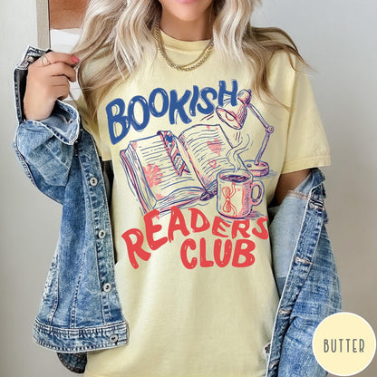 Comfort Colors tee in Butter featuring illustrated book graphic with a lamp and a coffee mug design