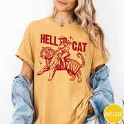 Comfort Colors tee in Mustard featuring western style graphic of a cowgirl riding a tiger
