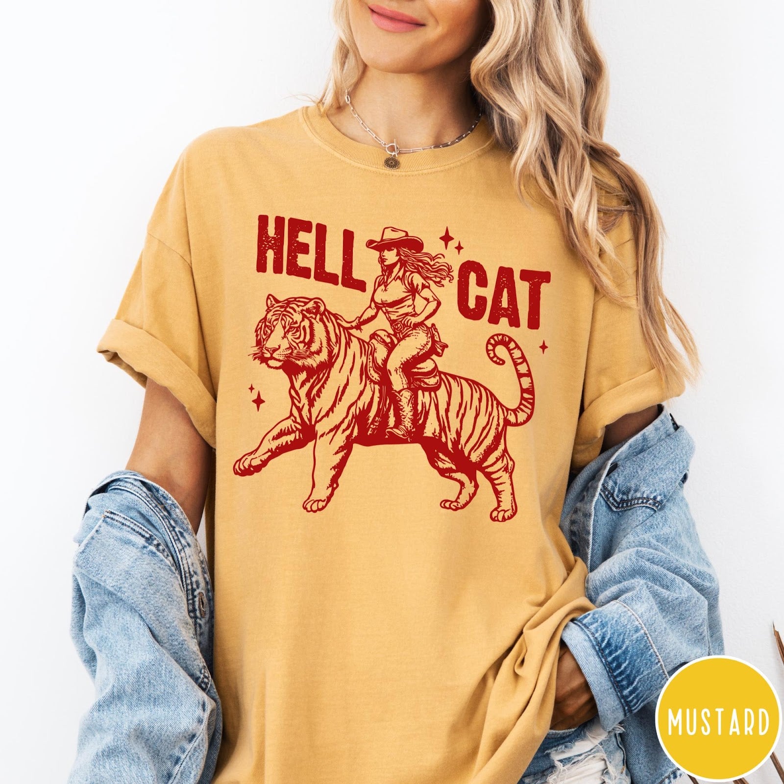 Comfort Colors tee in Mustard featuring western style graphic of a cowgirl riding a tiger