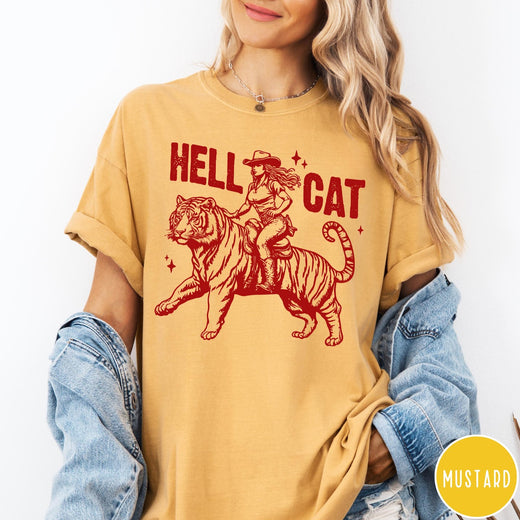 Comfort Colors tee in Mustard featuring western style graphic of a cowgirl riding a tiger