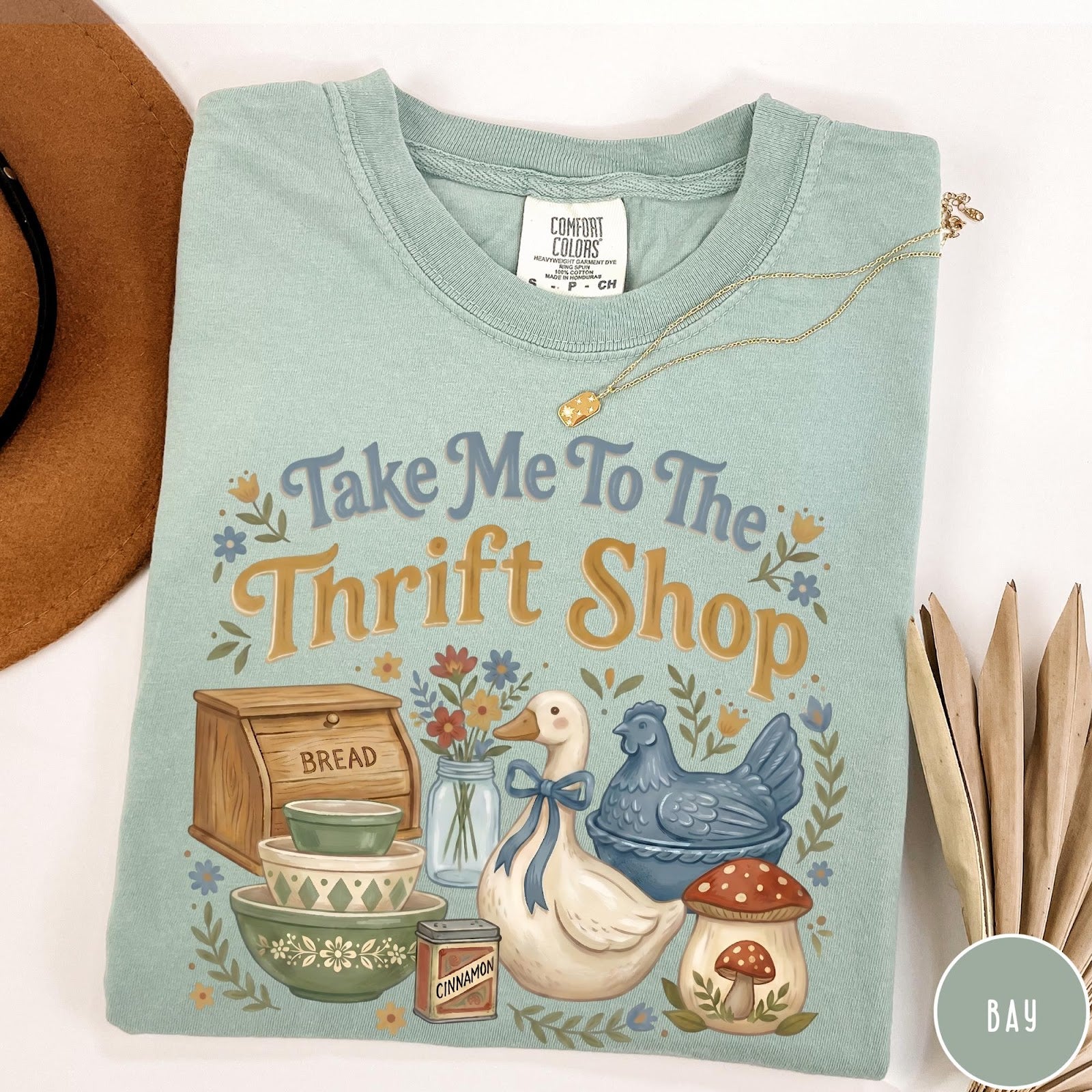 Comfort Colors tee in Bay featuring vintage kitchenware graphic with a duck, bread box, and mushrooms.