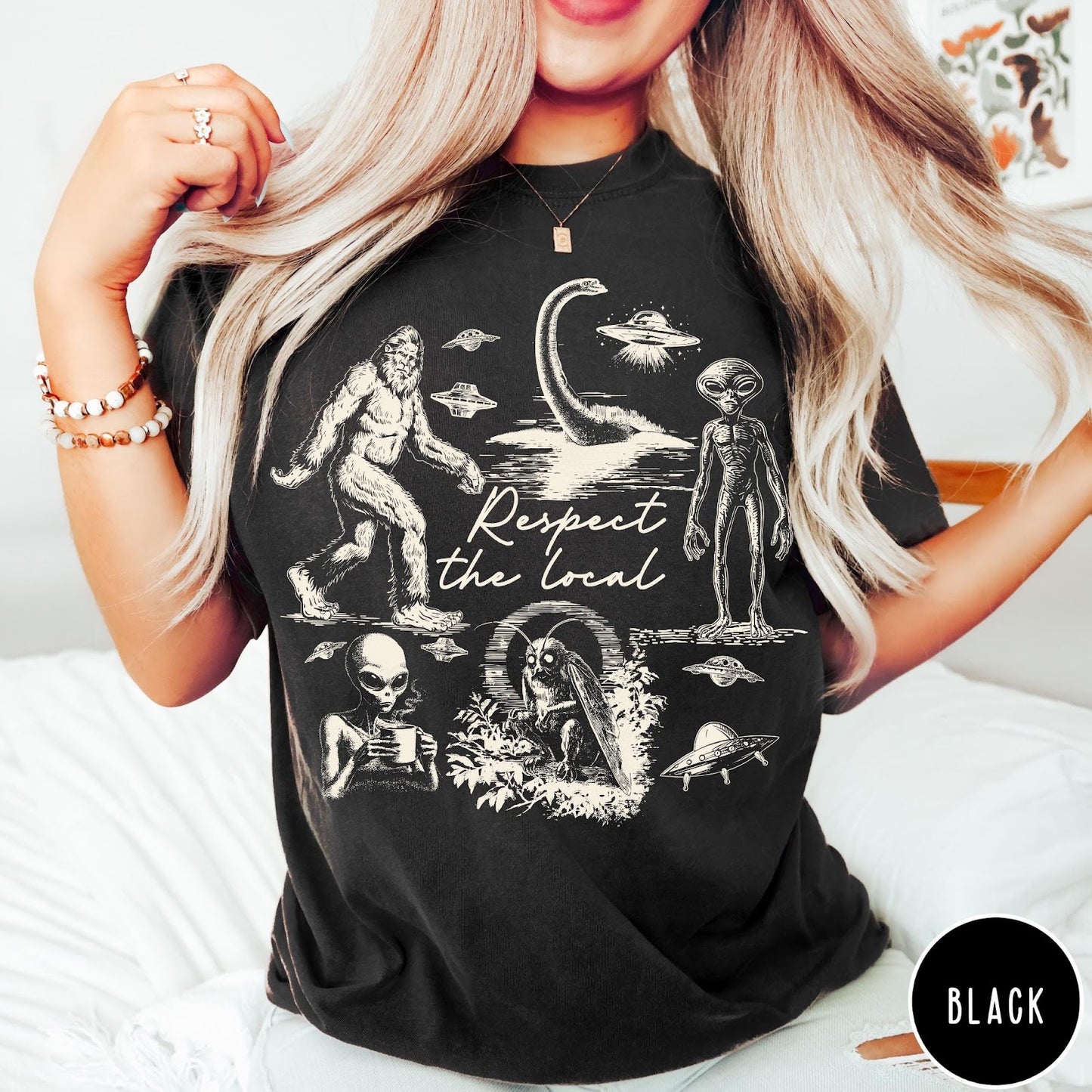 Comfort Colors tee in Black featuring vintage style cryptid graphic with Bigfoot, UFOs, and alien creatures.