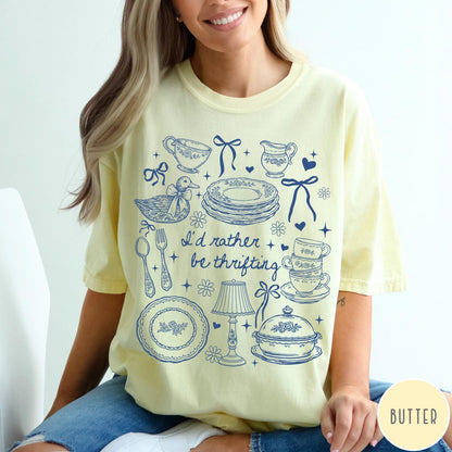 Comfort Colors tee in Butter featuring line art graphic of antique home goods and thrifting items
