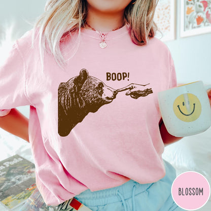 Comfort Colors tee in Blossom featuring a brown ink graphic of a human finger booping a bear nose