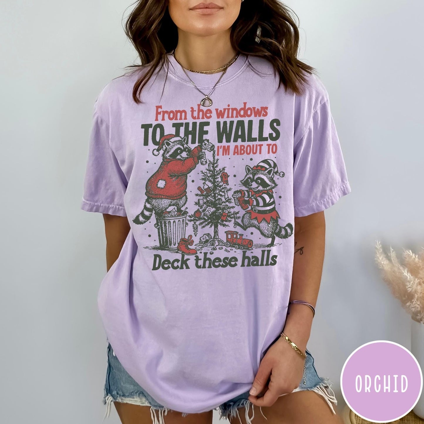 Comfort Colors tee in Orchid featuring festive raccoon graphic with Christmas tree and holiday text design elements