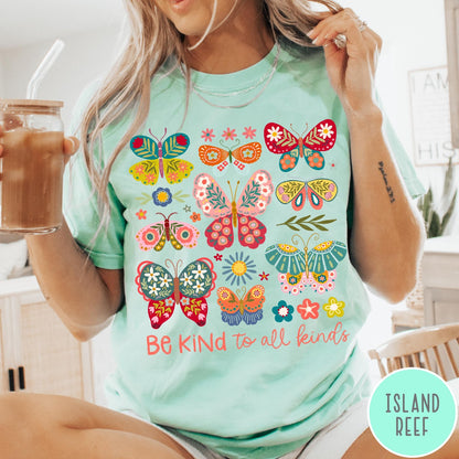 Comfort Colors tee in Island Reef featuring butterfly and floral graphic design with Be Kind to all kinds text