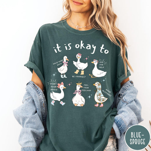 Comfort Colors tee in Blue Spruce featuring whimsical graphic style with six cute geese and motivational text phrases