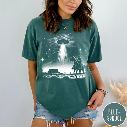 Comfort Colors tee in Blue Spruce featuring western graphic style with a cowboy riding a horse under a UFO