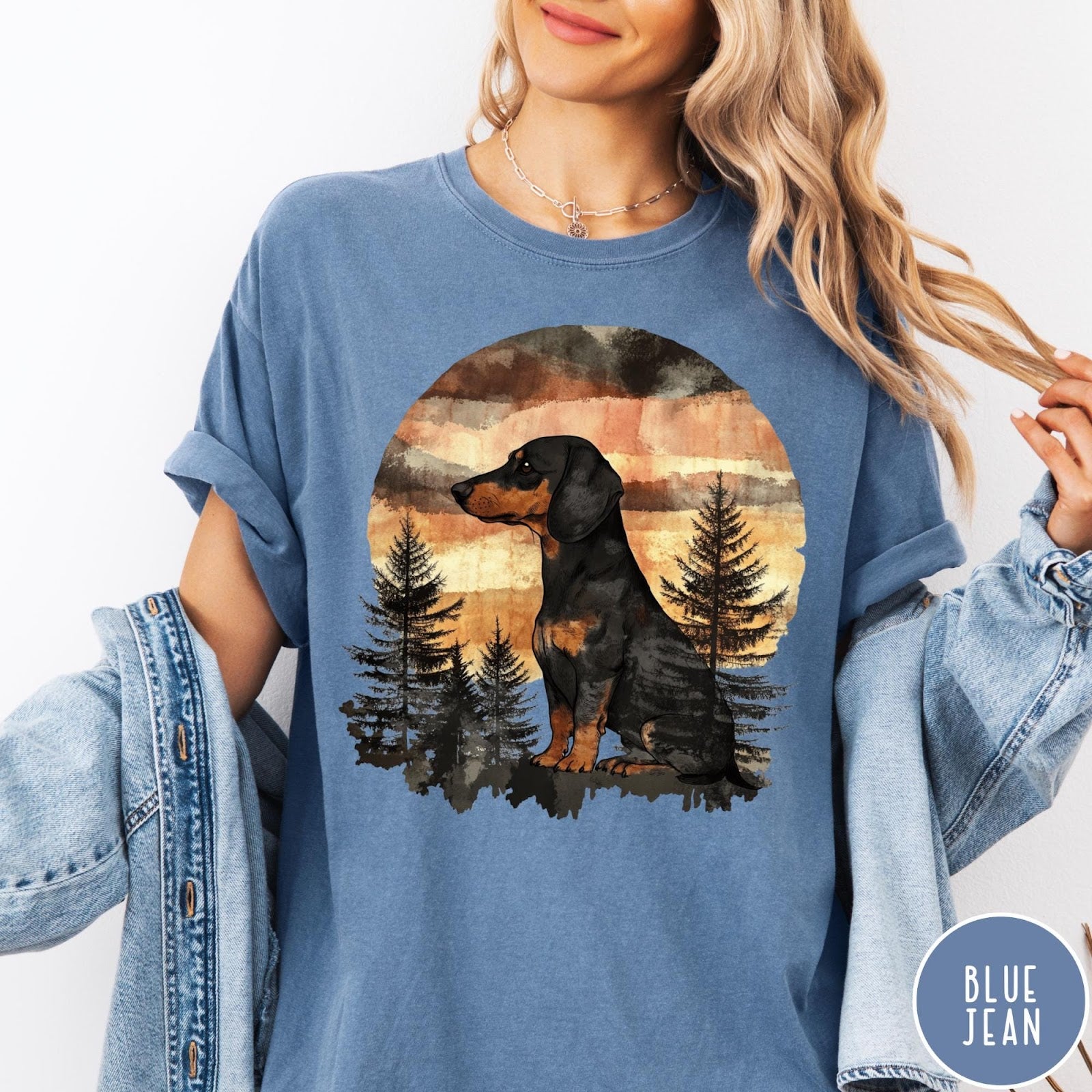 Comfort Colors tee in Blue Jean featuring vintage style dachshund dog graphic with forest and sunset background