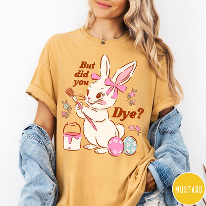 Comfort Colors tee in Mustard featuring Easter bunny design with paintbrush, paint bucket, and decorated Easter eggs